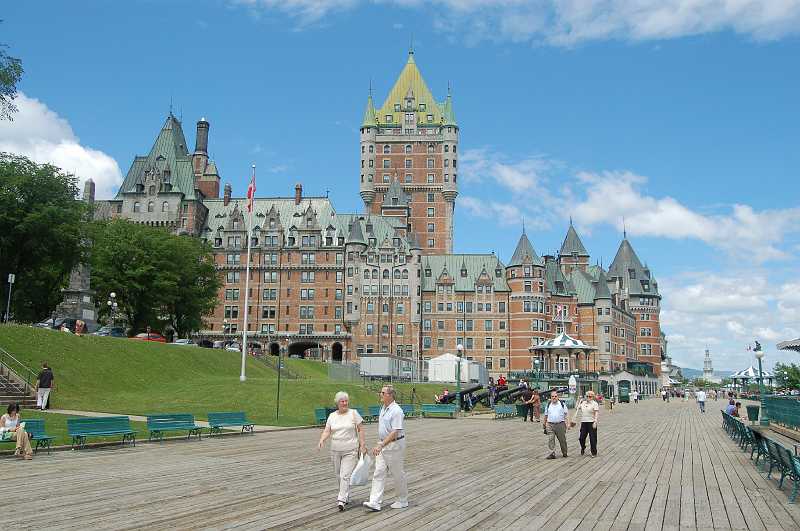 Canada East Tour 2006044.JPG - Quebec City's skyline is dominated by the massive Ch�teau Frontenac Hotel, perched on top of Cap-Diamant. The hotel is beside the Terrasse Dufferin (Dufferin Terrace), a walkway along the edge of the cliff, offering beautiful views of the Saint Lawrence River.  The Ch�teau Frontenac, with its outline of towers, steeply pitched roofs, and dormer windows, is the archetype of the ch�teau-style hotel and an unmistakable symbol of Quebec.